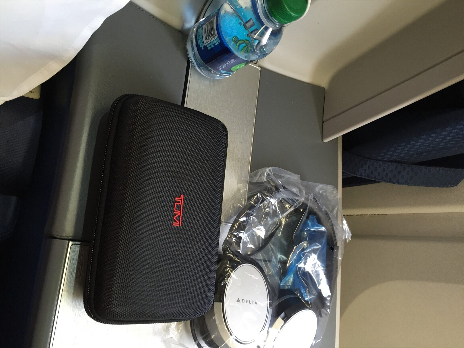 Tumi amenity kit, headphones, and water