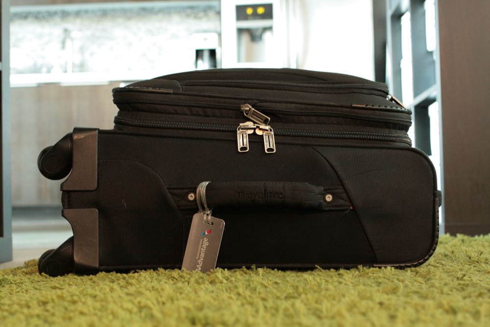 A traveler waits for a train with his Rimowa suitcase on a subway