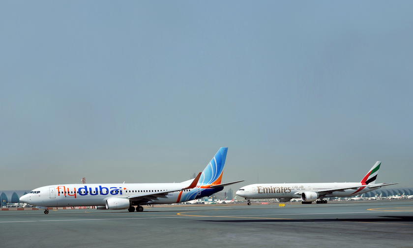 Flydubai and Emirates aircraft parked near each other at an airport