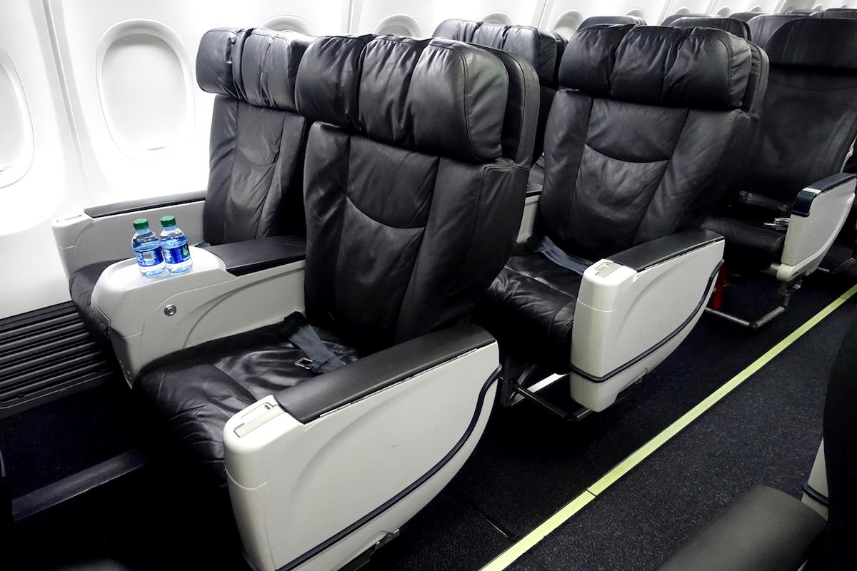 What is the process for making a first-class upgrade on Alaska Airlines
