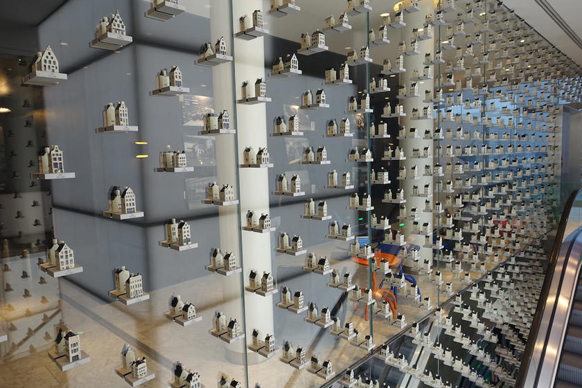 Shelves of KLM's Delft Blue miniature houses on display in the airline's Amsterdam lounge
