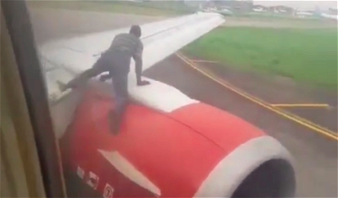 OMG: Man Climbs Onto Wing At Lagos Airport To Hitch A Ride