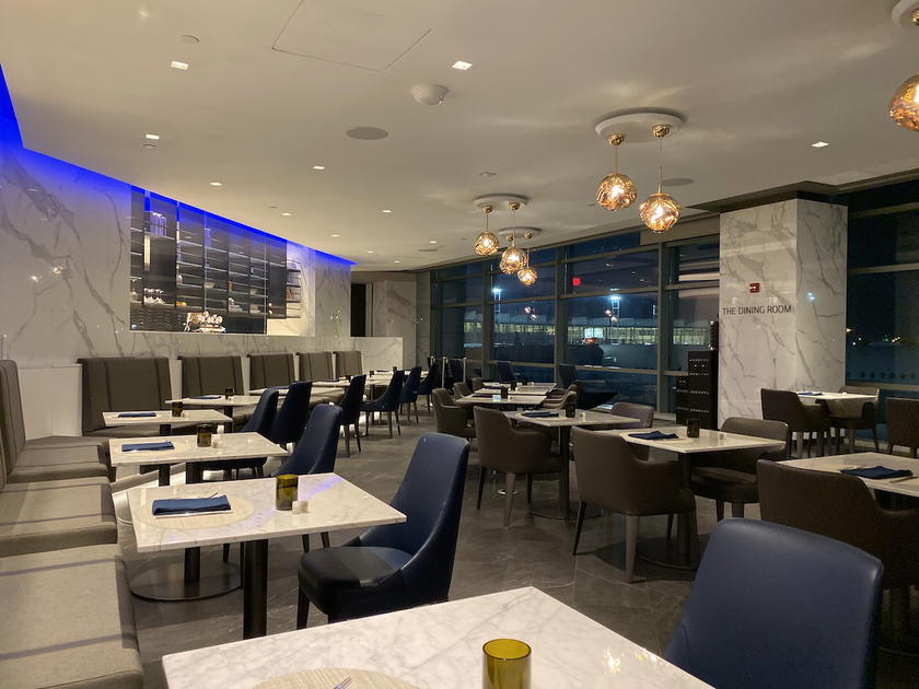 Seating and dining area inside a United Polaris Lounge