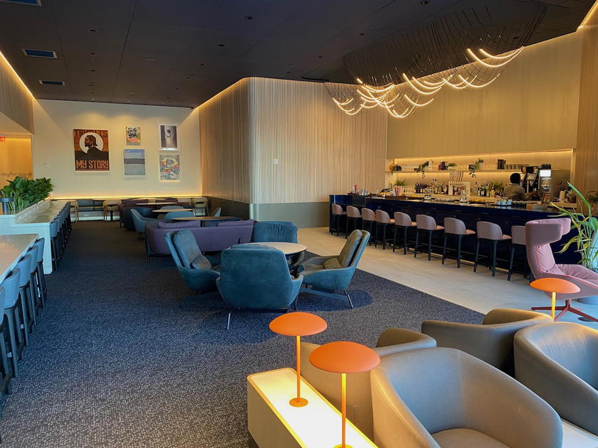 Seating and dining area inside the Capital One Lounge at Dallas/Fort Worth airport