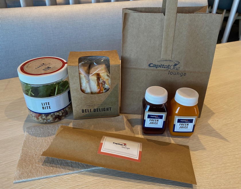 Seating and food area inside the Capital One Lounge at DFW Airport