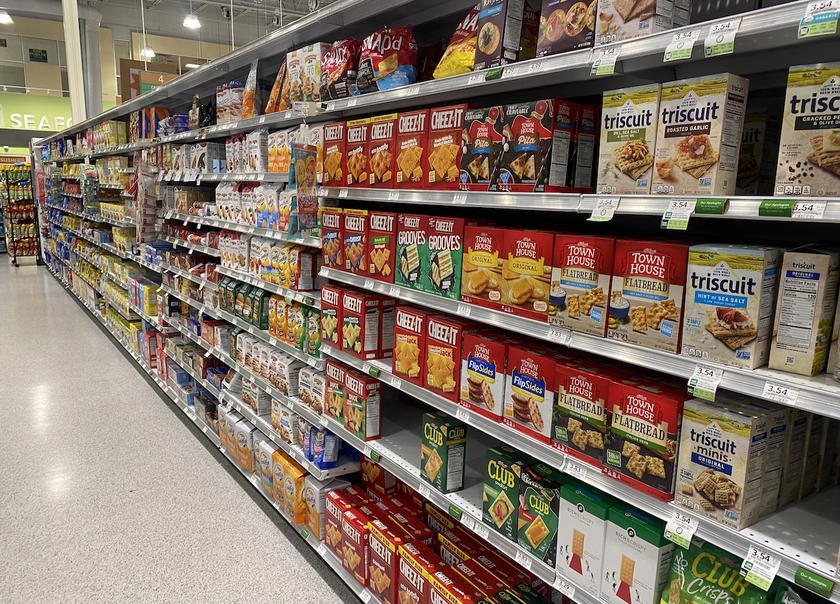 Aisle inside a grocery store lined with shelves of products