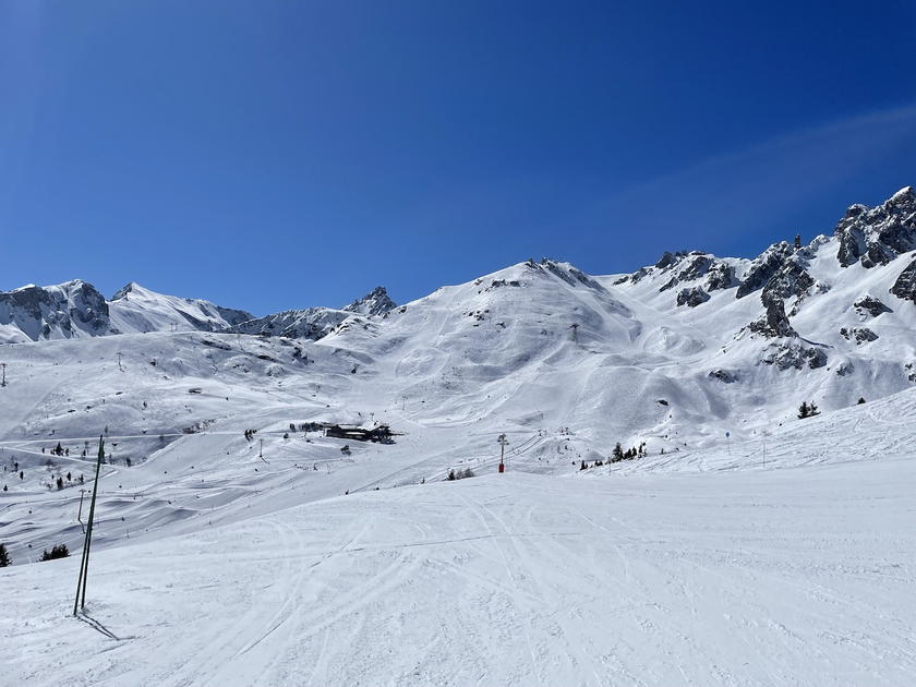 Snow-covered ski slopes and chairlift at Courchevel
