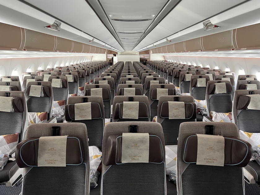Etihad A350 economy class cabin with rows of blue seats