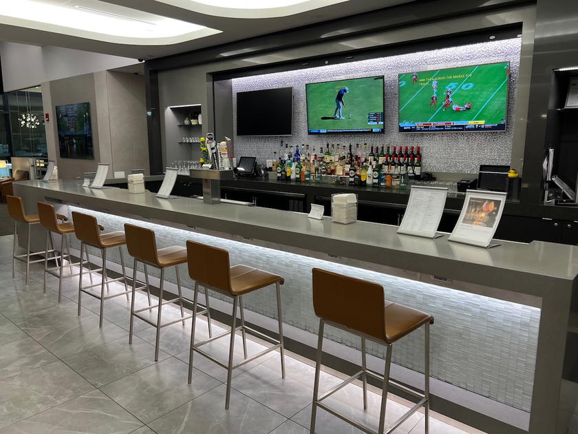 Lounge space at the American Airlines Admirals Club in Boston with seating and windows