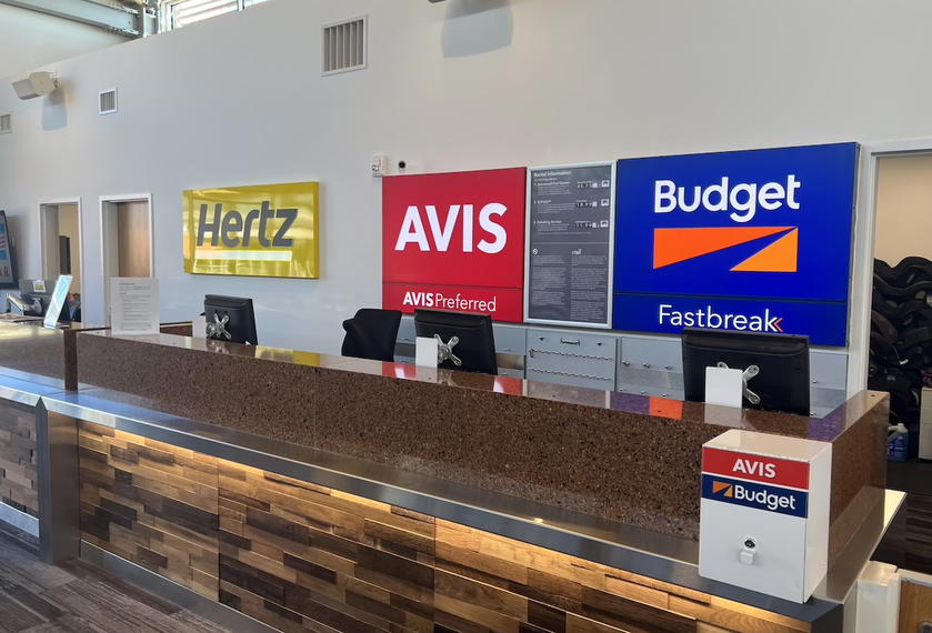 Hertz rental car counter with desk and signage