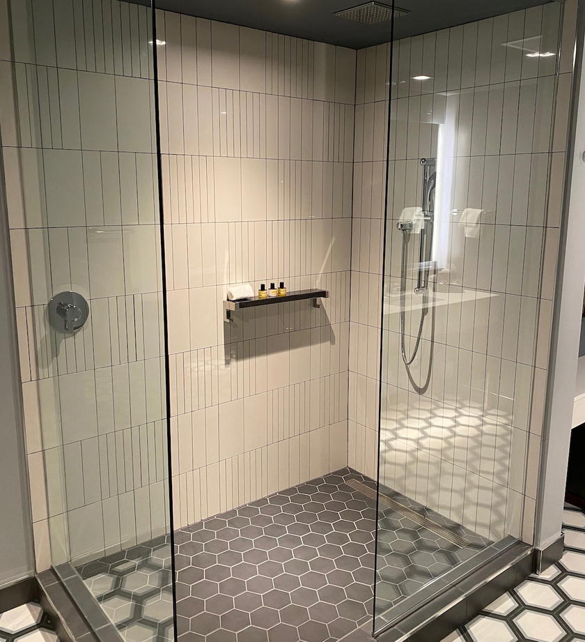 Modern hotel shower with rainfall showerhead at Thompson Dallas