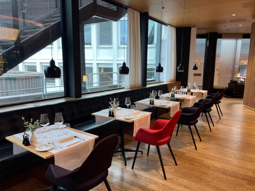Elegant dining area with table settings in the SWISS First Lounge Zurich Terminal A