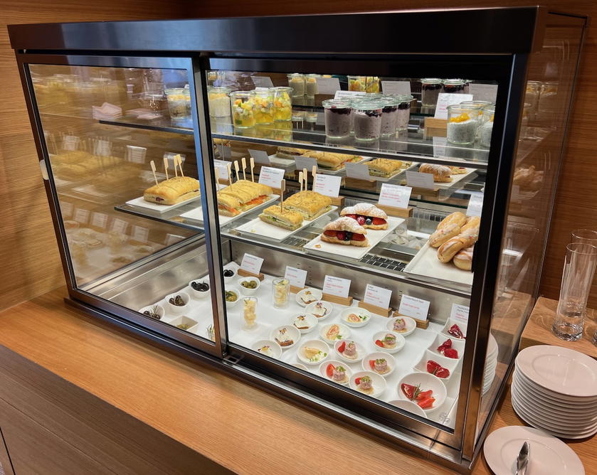 Refrigerated display with muesli, finger sandwiches, and pastries in the SWISS First Lounge Zurich