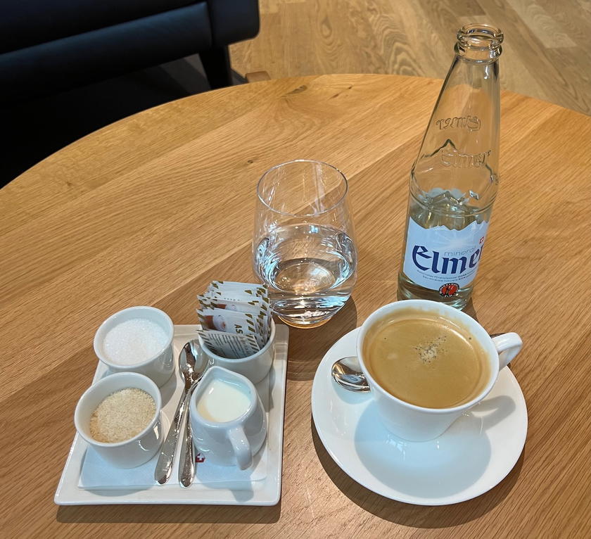 An americano and a glass of still water served in the SWISS First Lounge Zurich