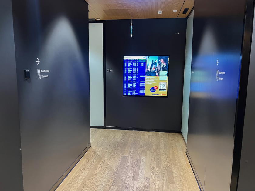 Men's restroom with sinks and stalls in the SWISS First Lounge Zurich