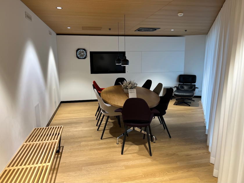 Conference room with a table seating eight in the SWISS First Lounge Zurich