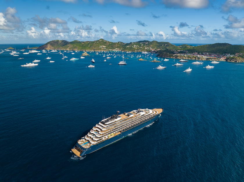 Ritz-Carlton Yacht Collection ship sailing near a coastal destination