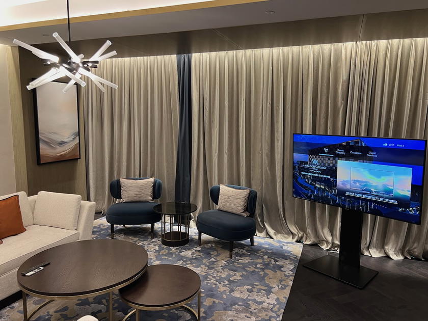 Hotel room with television and seating area at Waldorf Astoria Kuwait