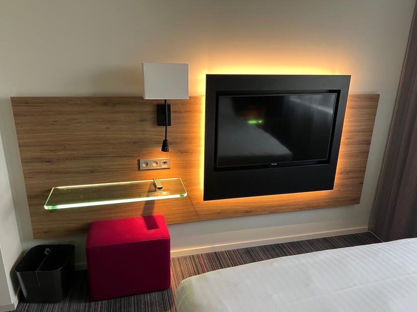 Small vanity-style desk and stool in hotel room at Moxy Paris Charles de Gaulle Airport