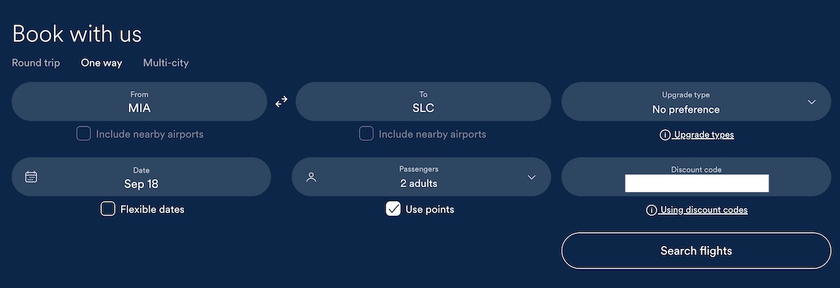 Alaska Airlines booking homepage with the companion discount code auto-filled