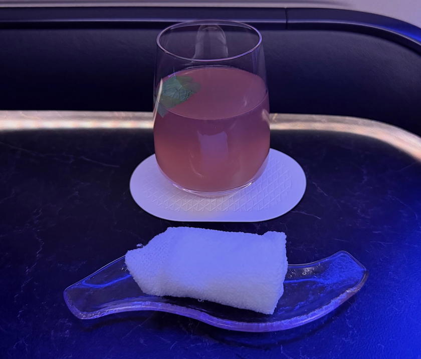Riyadh Air business class pre-departure drink and warm towel
