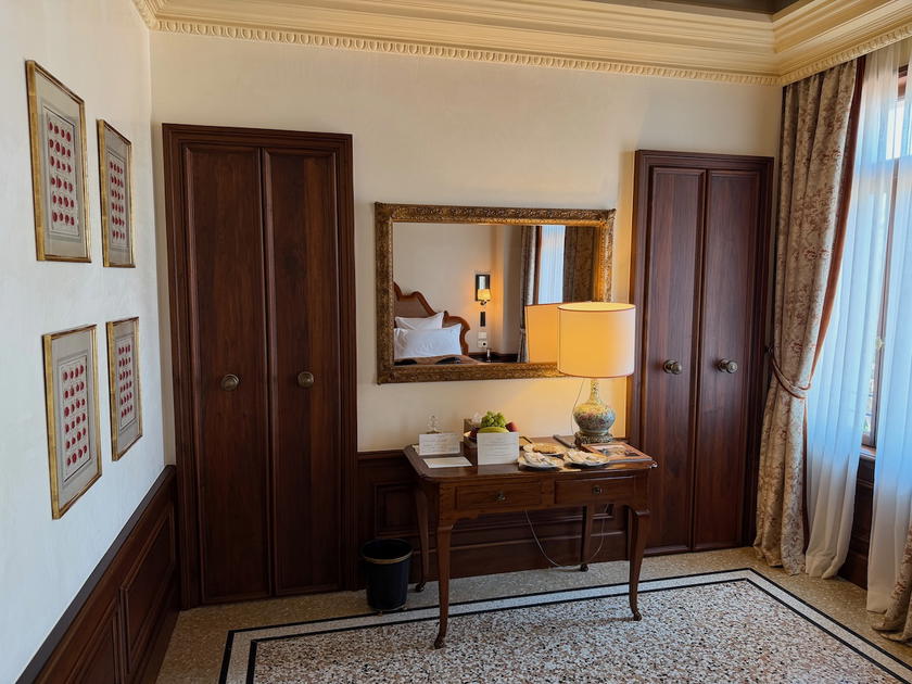 Hotel room corner with a single accent chair and no other seating furniture