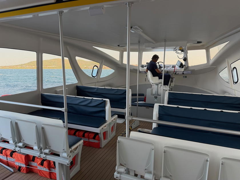 Tender boat docked alongside Four Seasons Yachts