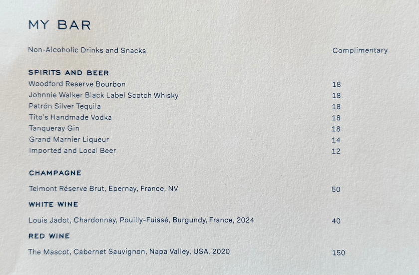 Minibar price list displayed in a Four Seasons Yachts suite