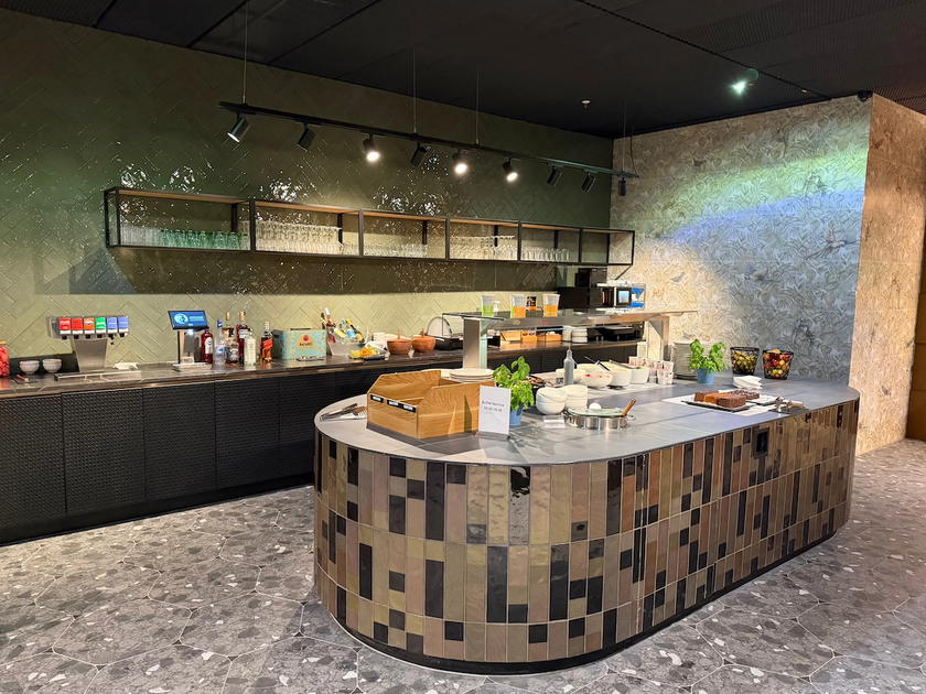 Seating and food service area inside a Priority Pass lounge at Frankfurt Airport