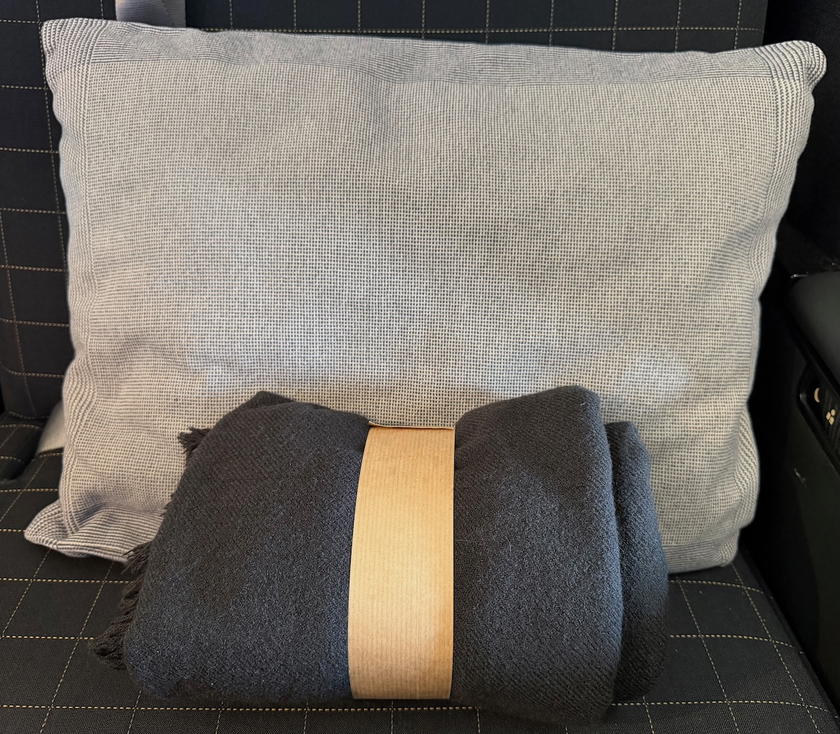 Pillow and blanket waiting at a SWISS first class seat