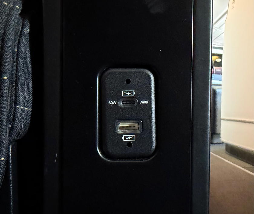 USB-A and USB-C charging ports by the aisle in the SWISS first class double suite
