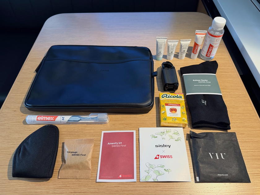 SWISS first class amenity kit leather binder opened at the seat