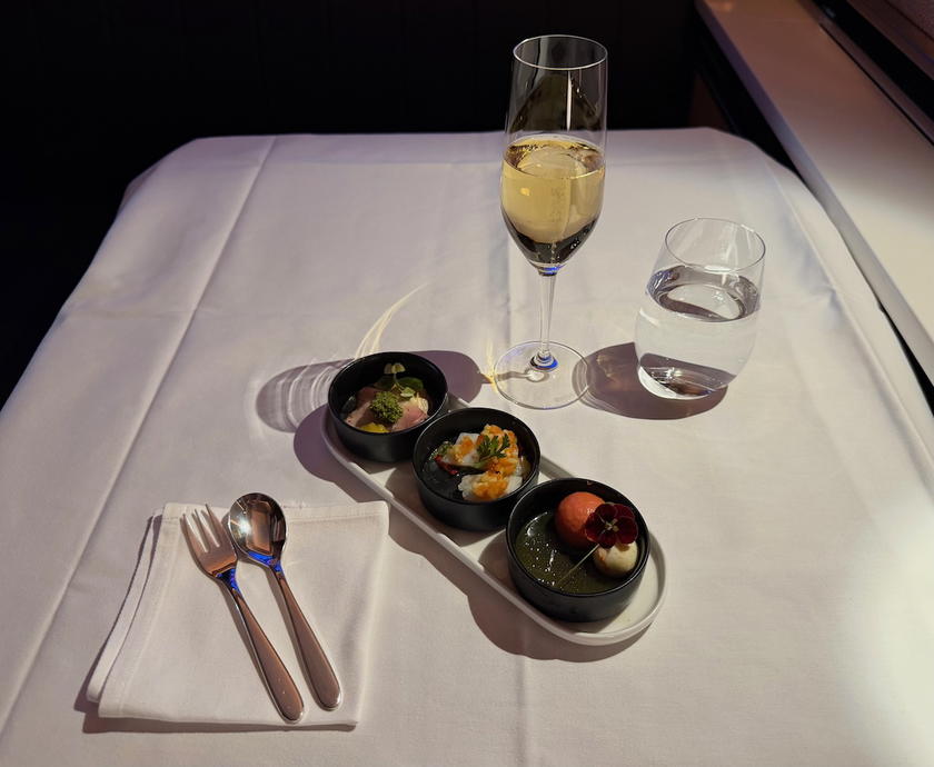 Amuse bouche trio served in SWISS first class alongside a glass of Champagne