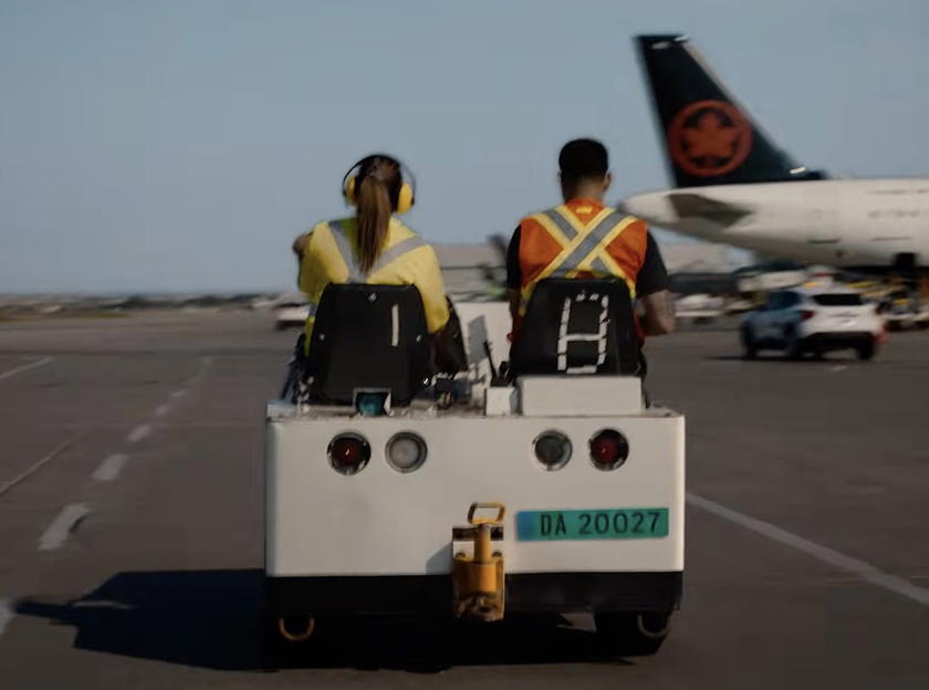 Baggage cart in Air Canada teaser video with 'DA 20027' written on the back