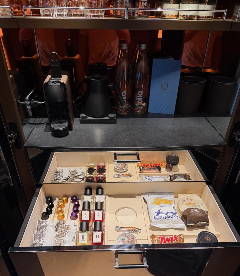 Minibar stocked with snacks and spirits in an Orient Express Corinthian suite