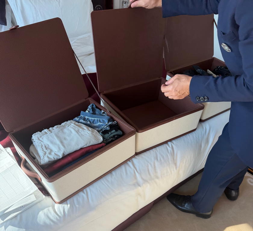 Freshly laundered clothes folded in a leather box as part of Orient Express Corinthian's laundry service