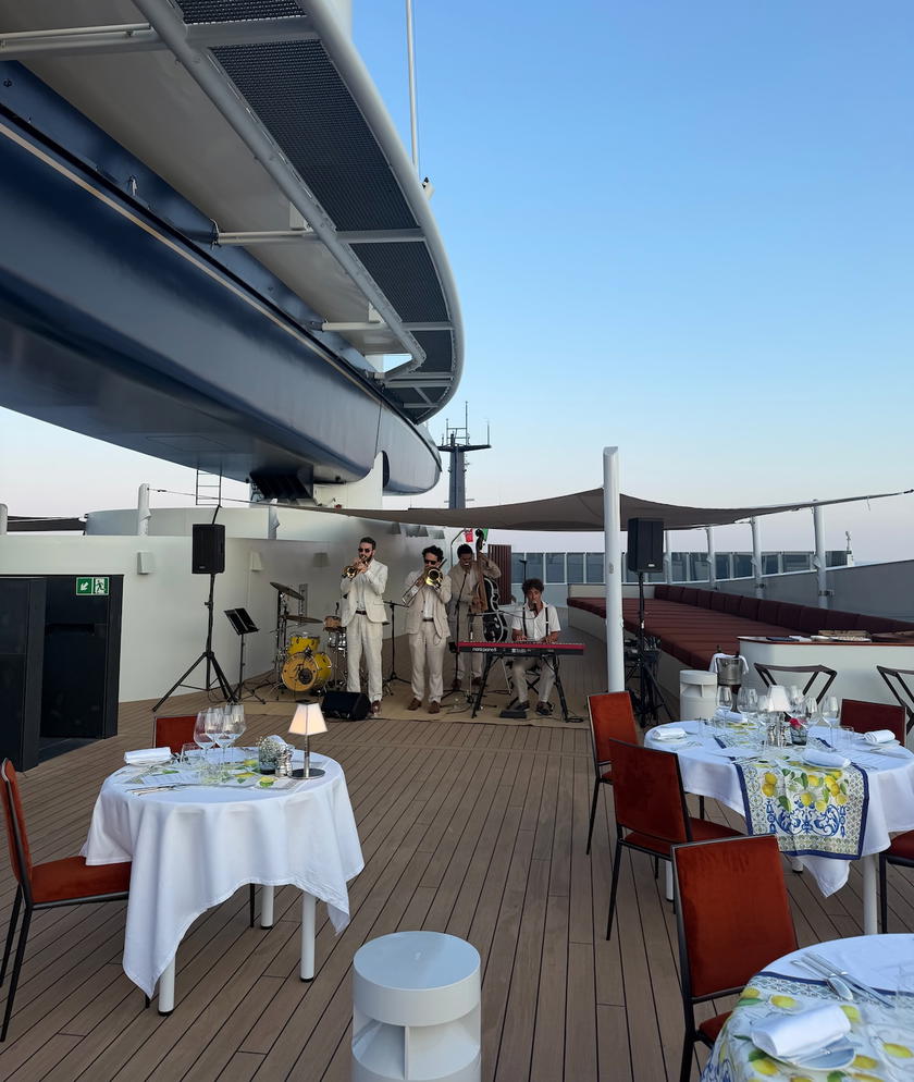 A table set for the sunset dinner beneath the sails aboard Orient Express Corinthian