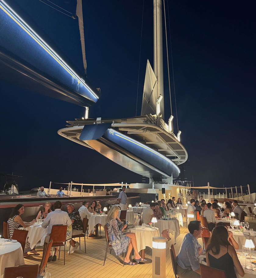 Guests dining beneath the sails at sunset aboard Orient Express Corinthian