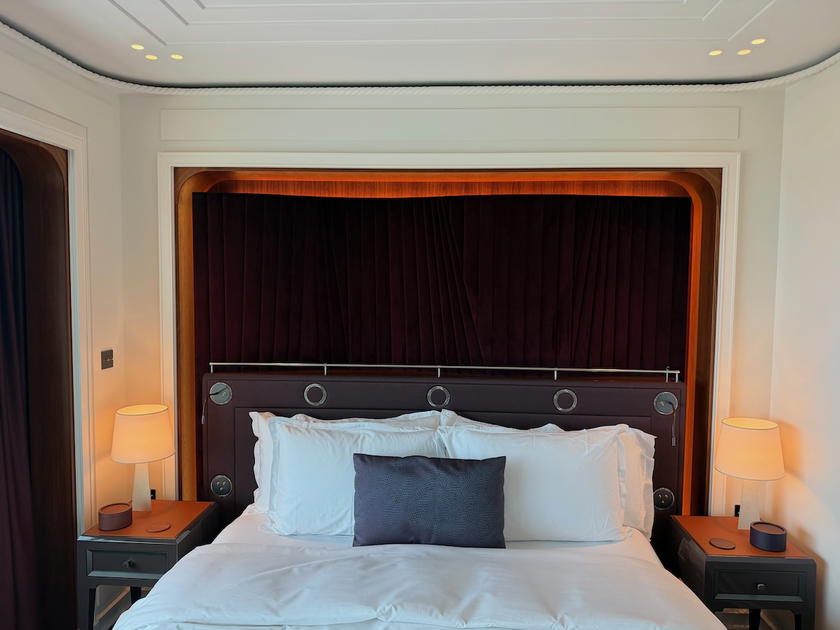 Bed and desk in an Orient Express Corinthian suite bedroom
