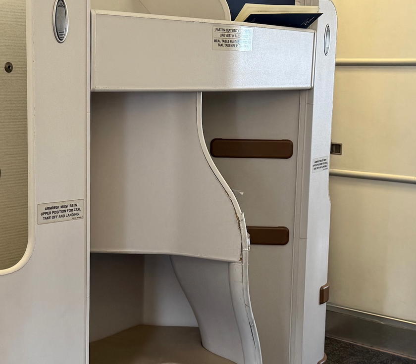 Worn upholstery and visible wear and tear on a Philippine Airlines A330 business class seat