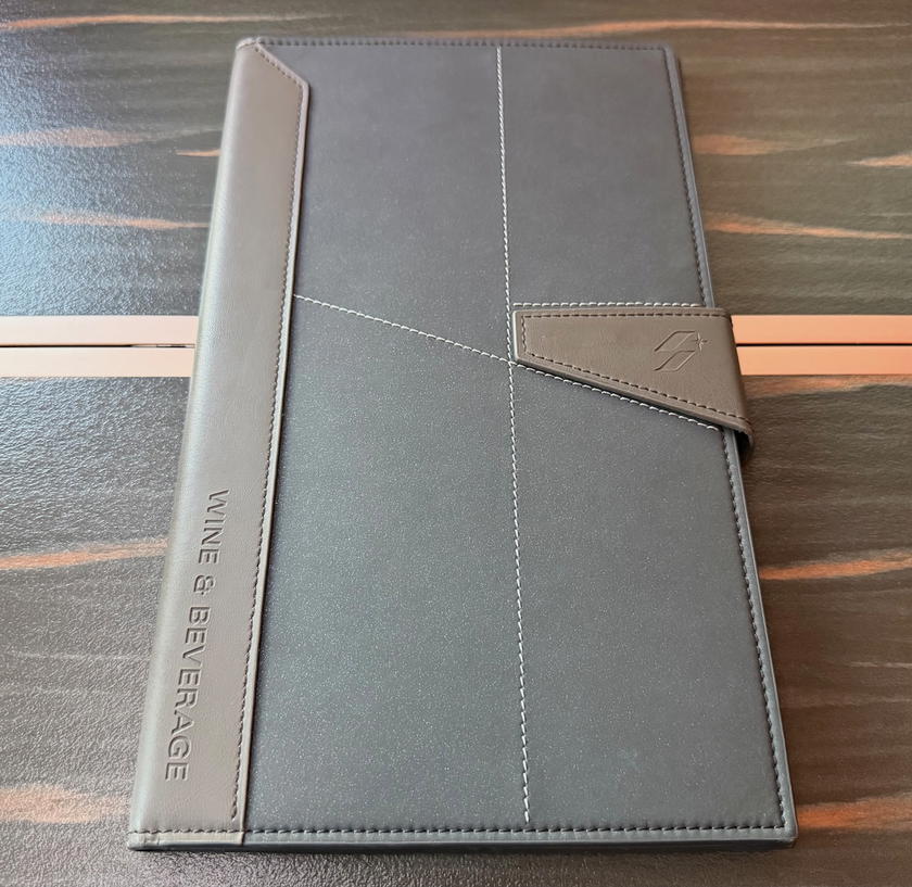 Starlux-branded binder containing the first class menu