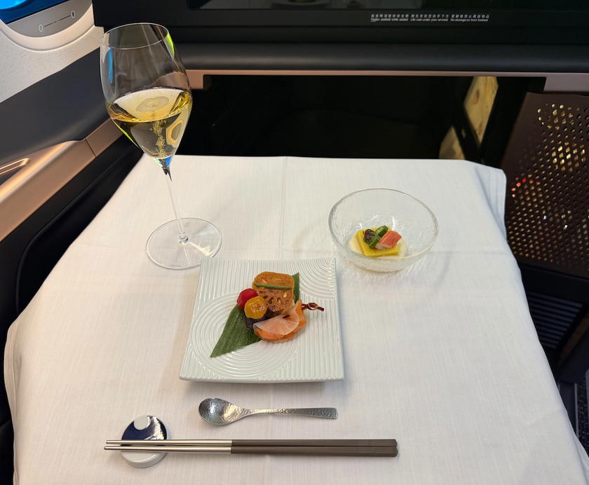 Japanese-style appetizer and glass of Bollinger champagne in Starlux first class