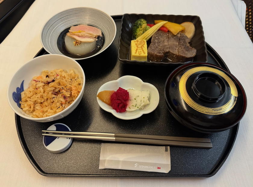 Starlux first class main course of HUTONG salt baked truffle wagyu steak with miso soup, crab fried rice, and duck breast
