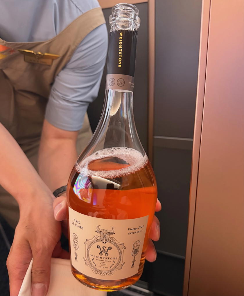Glass of sparkling ros&eacute; wine served with the main course in Starlux first class