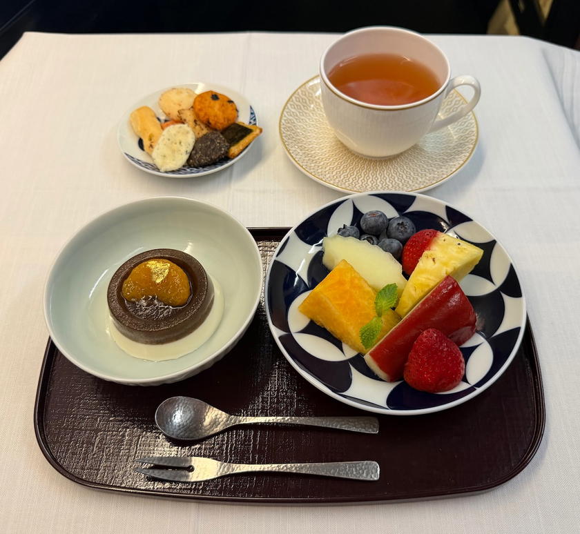 Starlux first class dessert of fresh fruit and amazake panna cotta with white peony tea