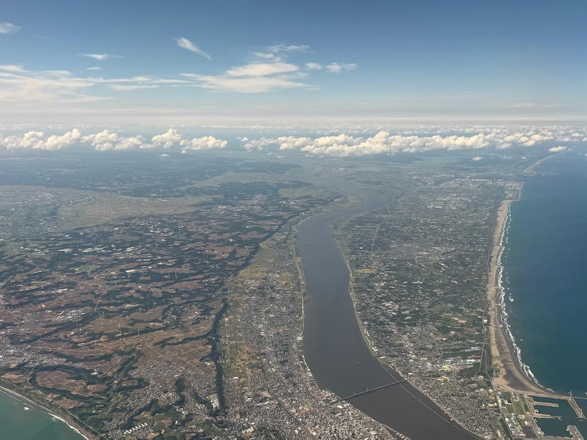 Aerial view of land below while approaching Tokyo Narita Airport