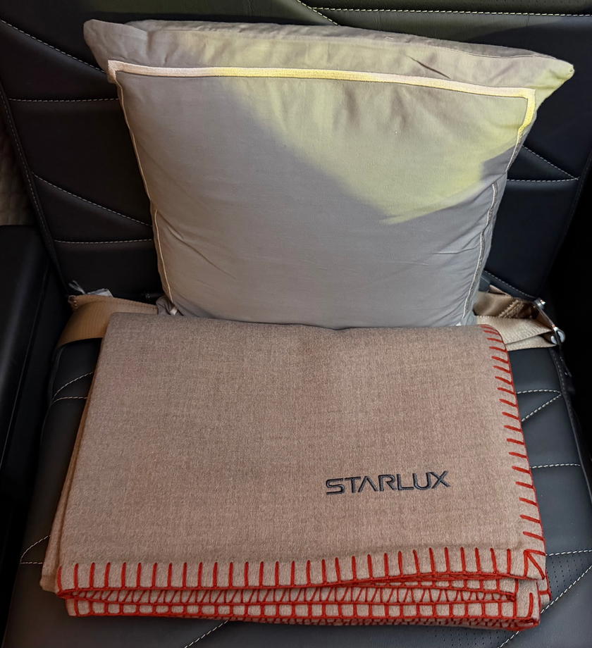 Starlux Airlines first class pajamas laid out on the seat