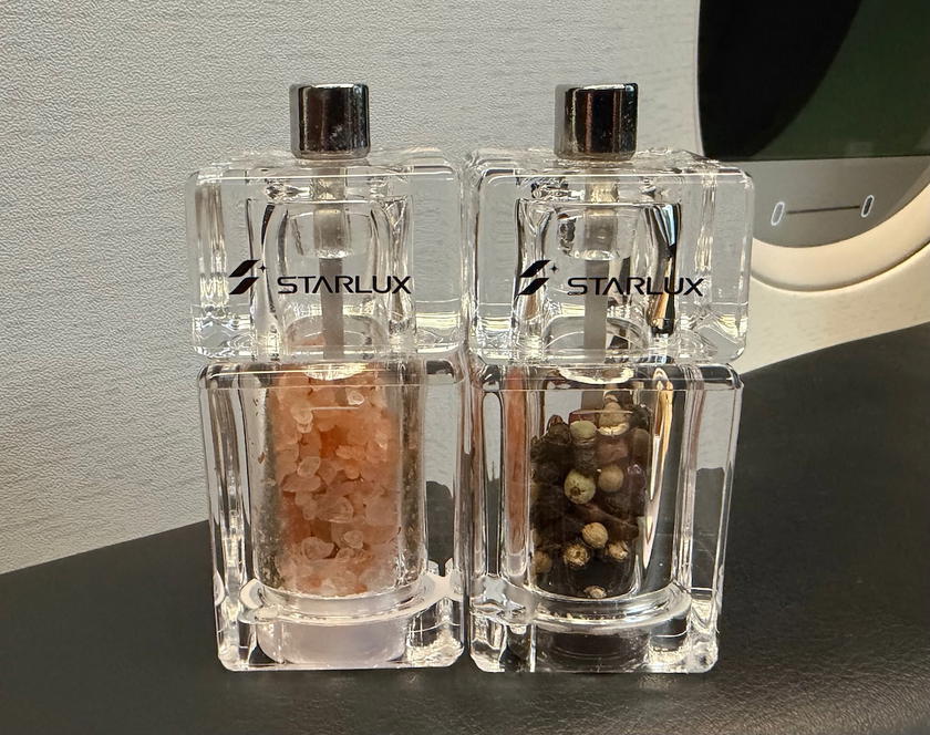 Salt and pepper shaker set on the tray table in Starlux Airlines A350 first class