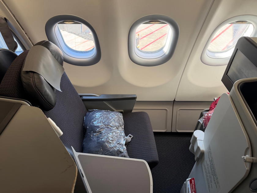 Close-up view of an Air Algerie A330-900neo business class window seat