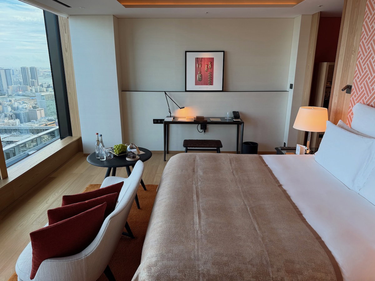 Seating area with a chair and coffee table beside the bed in the deluxe room